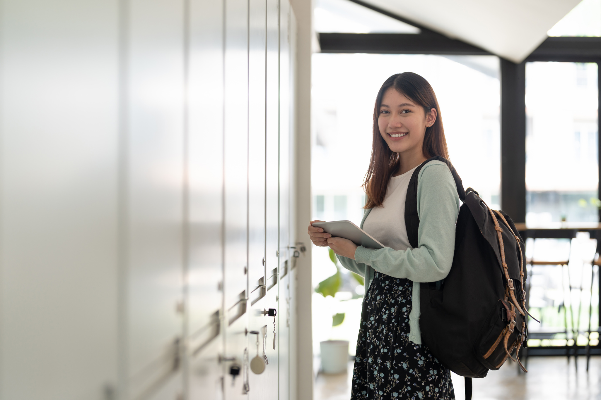 Portrait young asian woman student holding digital tablet at